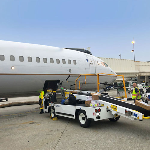 baggage being loaded in flight through a loading conveyor belt
