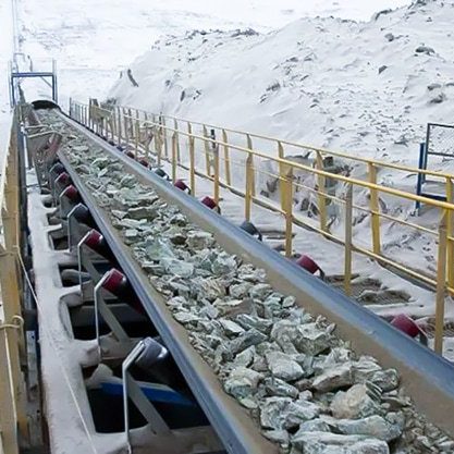 heavy stones being carried on Cold resistant conveyor belt. in hard cold snow Environment.