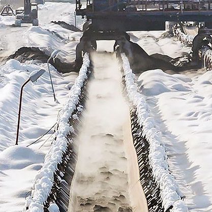 heavy stones being carried on Cold resistant conveyor belt. in hard cold snow Environment