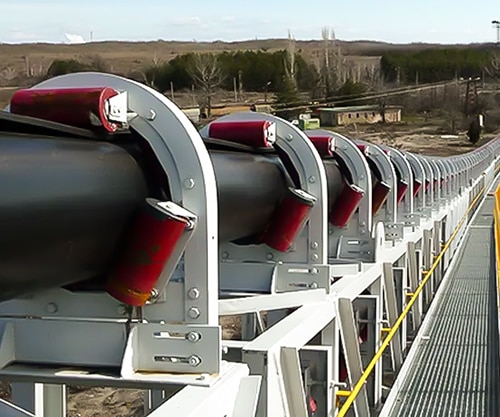 pipe conveyor belts transports materials in a large field