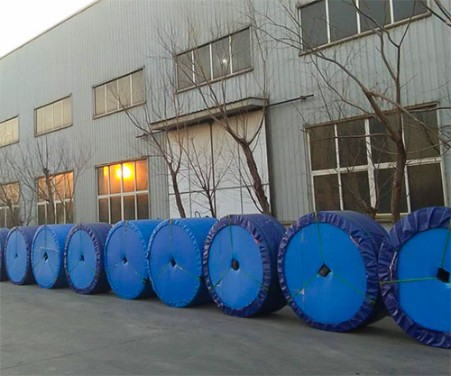 line of rolled conveyor belts in long time storage.